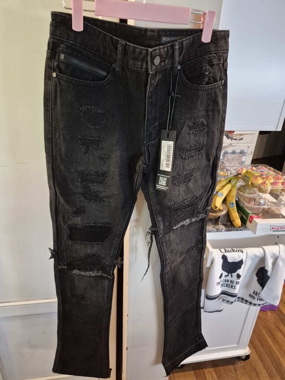 black Rockstar Original jeans feature extensive rips and distressed detailing th
